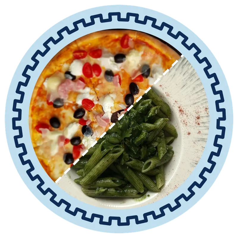 Half a pizza with olives and cherry tomatoes next to green penne in a white bowl